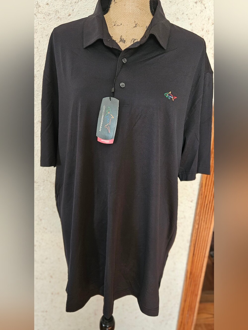 Brand New With Tag. Greg Norman Collection Black Polo with Multicolor Shark Logo